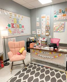 an office with two chairs and a desk in the middle, decorated with posters on the wall