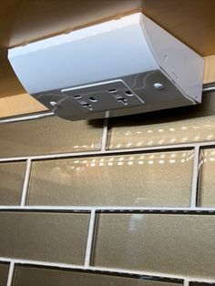 a white stove top oven sitting on top of a kitchen counter next to a tiled wall