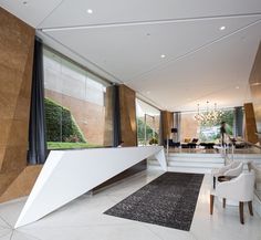 a living room filled with furniture and large windows