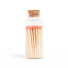 matches in a glass jar on a white background