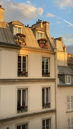 an apartment building with lots of windows and balconies on the top floor in paris