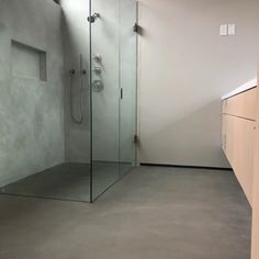 an empty bathroom with a glass shower stall