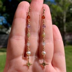 Crystal & Pearl Brass Star Earrings Crystals: Rhodonite, Amethyst, Lapis, Ocean Jasper  Made to order with genuine crystal & pearl beads & tarnish resistant, gold colored jewelry wire. Due to being made to order, the color & shape of each bead may slightly differ. #boho #earrings #handmadejewelry #jewelry #hippie #handmade #handmadejewelry #crystaljewelry #beads #boho labradorite crystal earrings threader dangly hippie earthy fairy core Minimalist Dangling Earrings, Diy Prom Jewelry, Gold Crystal Jewelry, Crystal Bead Jewelry Ideas, Handmade Earrings Ideas Beads, Boho Gold Jewelry, Bead Wire Earrings, Cute Handmade Jewelry, Cristal Earring