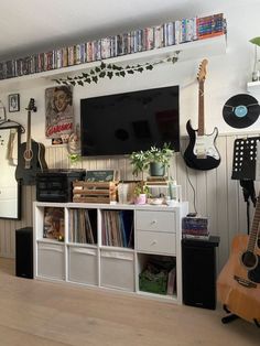 a living room filled with furniture and a flat screen tv mounted to the side of a wall