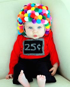 a small child wearing a clown hat and sitting on a couch with the number twenty five