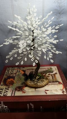 a small white tree sitting on top of a table