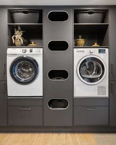 a washer and dryer in a room next to each other with baskets on the shelves