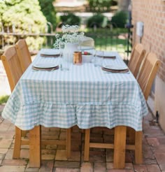 a table set for two with plates and cups on it