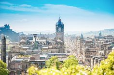 a view of a city with tall buildings and a clock tower in the distance,