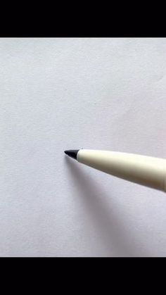 a black and white pen sitting on top of a piece of paper