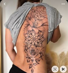 a woman's back with flowers on it