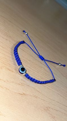 Handmade simple blue evil eye bracelet. Adjustable Round Evil Eye Bracelet, Handmade Blue Evil Eye Bracelet Casual Style, Blue Evil Eye Round Bracelets, Blue Round Evil Eye Bracelets, Blue Beaded Bracelets With Evil Eye, Blue Evil Eye Round Beaded Bracelets, Adjustable Blue Friendship Bracelets With Evil Eye, Adjustable Blue Beaded Bracelets With Evil Eye, Adjustable Blue Evil Eye Beaded Bracelets