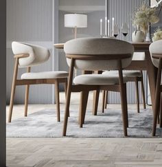 a dining room table with chairs and a rug on the floor in front of it