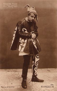 an old black and white photo of a man in costume