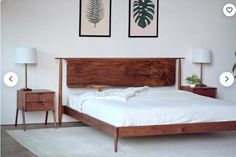 a bed sitting in a bedroom next to two framed pictures on the wall above it