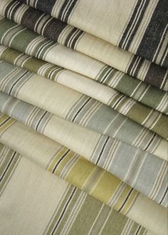 a stack of different colored striped fabrics