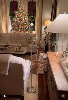 a living room filled with furniture and a christmas tree