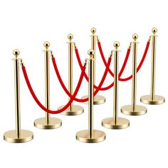 a row of gold poles with red ropes