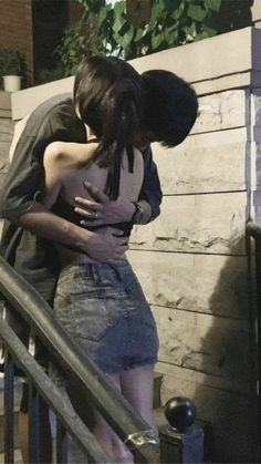 two people hugging each other on the stairs