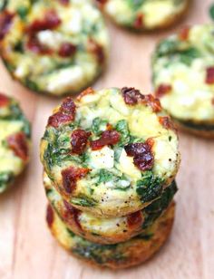 mini frittatas with spinach, bacon and cheese are stacked on top of each other