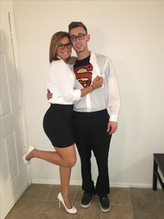 a man and woman are dressed up as superman and the girl is wearing a white shirt