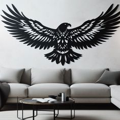 a living room with a large black bird on the wall