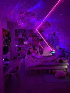 a bedroom with purple lighting and pictures on the wall