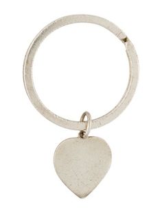 a heart shaped keychain with a small metal object hanging from it's side