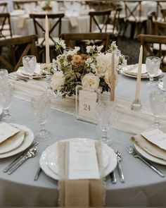 the table is set with place settings and silverware for an elegant wedding reception or special event