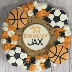 a birthday cake decorated with basketballs and soccer balls