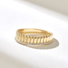 a gold ring with rows of diamonds on it