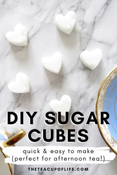 the words diy sugar cubes are on top of a marble table with white hearts