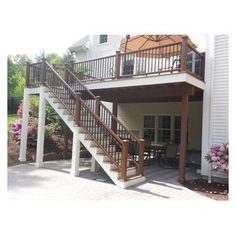 an outdoor patio with stairs leading up to the deck