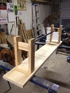 a dog is standing next to a work bench made out of plywood and wood