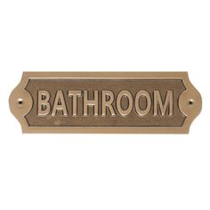 bathroom sign with the word bath room in gold and black on an aged bronze background