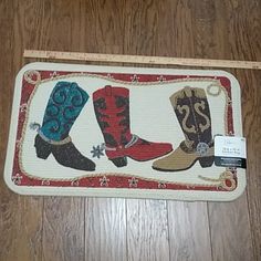 the rug has three cowboy boots on it