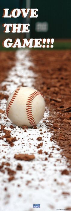 a baseball sitting on top of a field covered in dirt and mud next to home plate