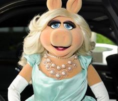 the miss piggy is sitting in her car