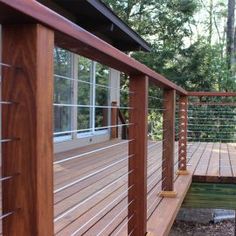 a wooden deck next to a small pond