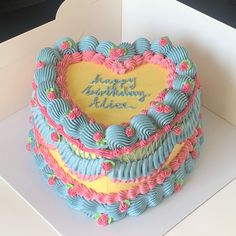 a heart shaped birthday cake in a box