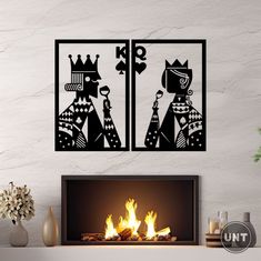 two black and white art pieces sitting on top of a fireplace next to a fire place