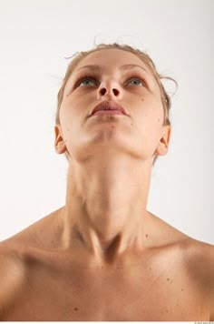 a woman with her eyes closed looking up to the sky, while she is wearing no shirt