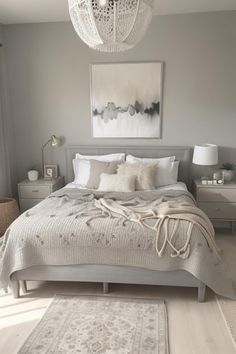 a bedroom with a large bed and white rugs