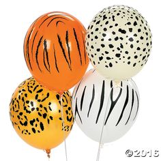 three balloons with different designs on them in the shape of zebras and cheetah