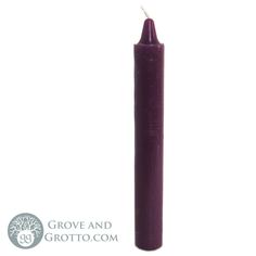 a purple candle with a white top on a white background