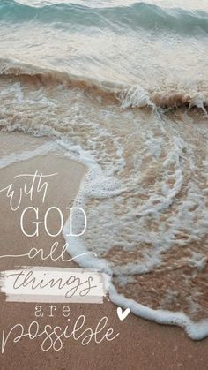 the words with god are things are possible written in white ink on an ocean beach