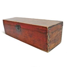 an old wooden box sitting on top of a white surface