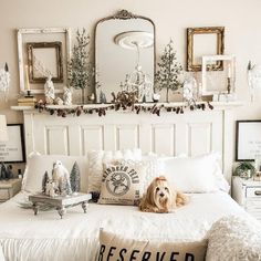 a dog laying on top of a bed in a room with white furniture and decorations