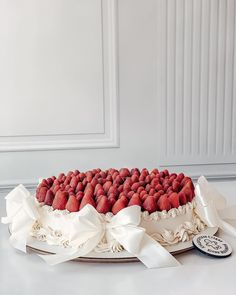 a large cake with strawberries on top