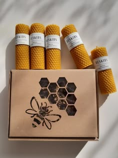 six bees are in a box with labels on the top and bottom, sitting next to each other